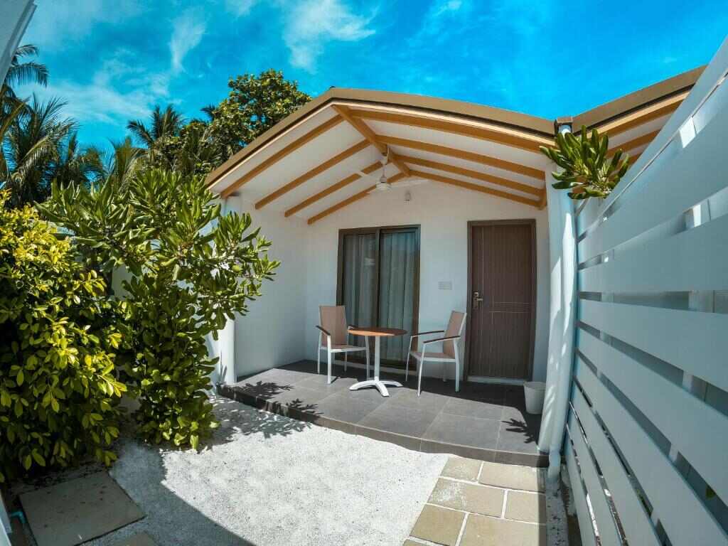 Guest room terrace with table and chairs at RV Thoddoo Maldives