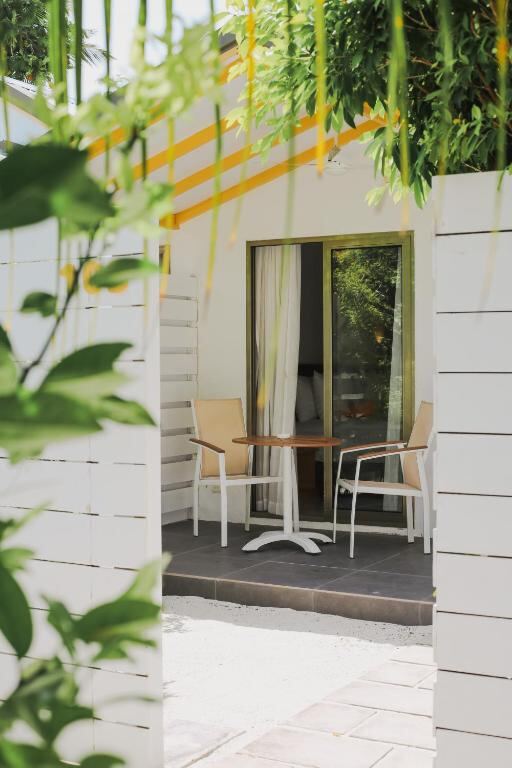 Private terrace seating framed by tropical greenery